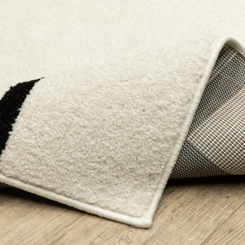 Tapete Reyna Deco en Marfil con Negro, detalle del reverso