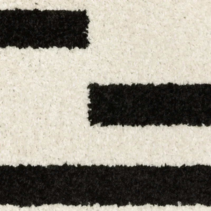 Tapete Reyna Rayas Rotas en Marfil con Negro, detalle de la textura 3