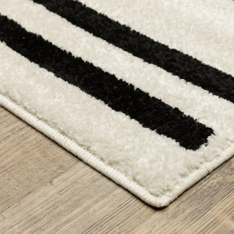 Tapete Reyna Rayas Rotas en Marfil con Negro sobre el piso 2