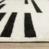 Tapete Reyna Rayas Rotas en Marfil con Negro, detalle de la textura